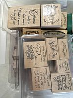 Close-up image of wooden rubber stamps with phrases like 'Christmas makes me so happy' and 'Thanks a bunch!'