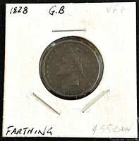 Front side of the 1828 King George IV copper farthing coin mounted in white cardboard holder, showing King George IV profile.