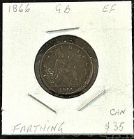 Front side of bronze 1866 Great Britain Queen Victoria farthing coin showing seated Britannia with date and details handwritten on holder.