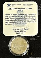 Photo of coin in protective casing with label detailing specifications and design by Romeo Bukauskas, describing Percé Rock and its importance.