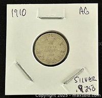 Reverse side of the 1910 Canadian silver 10 cents coin showing the denomination and wreath design with handwritten notes on holder indicating year and silver content.