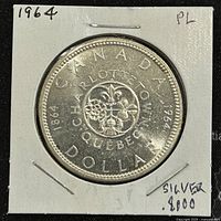 Reverse side featuring the 1867-1964 commemorative floral design, showing Canadian provinces and inscriptions "CANADA DOLLAR" and "CHARLOTTETOWN QUEBEC", noting silver content as .800.
