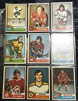 Nine 1974-75 O-Pee-Chee hockey player cards displayed on a black surface showing front player images and team logos.