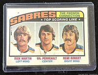 Front of 1976-7 O-Pee-Chee Buffalo Sabres French Connection top scoring line hockey trading card showing portraits of players Rick Martin, Gil Perreault, and Rene Robert.