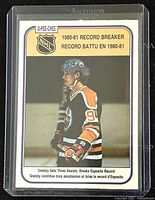 Front of 1980-81 O-Pee-Chee Wayne Gretzky Record Breaker hockey card #392 showing Gretzky in Edmonton Oilers jersey with record-breaking assist achievement text.