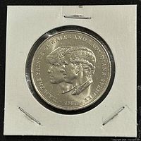 Obverse side of the 1981 commemorative coin showing Prince Charles and Lady Diana Spencer profiles with date 1981.