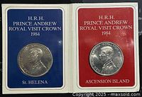 Obverse sides of two 1984 Prince Andrew Royal Visit Crown coins in presentation folders labeled St Helena and Ascension Island