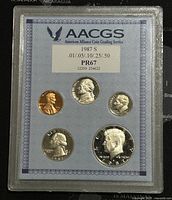 Obverse side of the 1987 US proof-like coin set showing Lincoln cent, Jefferson nickel, Roosevelt dime, Washington quarter, and Kennedy half dollar.