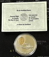 Photo showing the informational card about The De Havilland Beaver and first 50 years of powered flight in Canada, along with the coin in a protective case.