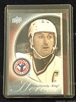 Front of the hockey card featuring Wayne Gretzky in Kings uniform with logos and text.