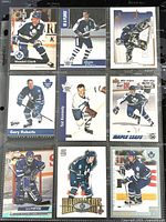 Front view of nine Toronto Maple Leafs hockey player trading cards inserted in a collector binder page.