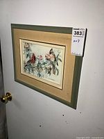 Framed print on white wall showing full frame and artwork including matting and signature.