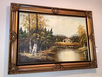 Full view of the framed oil painting showing a river or pond with birch trees, pine trees, and a rural house in the background.