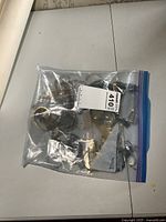 Plastic bag containing multiple watches loosely packed inside, various styles and bands visible through the bag