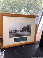 Full framed photo of historical Odessa street scene with wooden frame, showing tag with lot number.