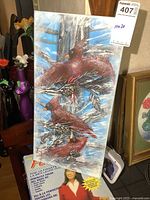 Full view of the vertically oriented painting depicting three red cardinals on branches against a blue sky