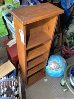 Front angle view of the solid pine wood shelving unit showing all shelves and wood grain.
