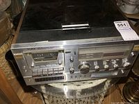 Front view photo of vintage Yorx stereo tuner with cassette, 8-track, and record player showing control knobs and cassette.