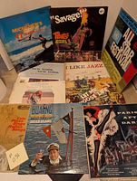 Photo showing all 10 vinyl records arranged with covers visible, featuring a diverse selection including jazz, boating, and international music.