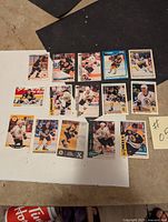 Fifteen Boston Bruins hockey trading cards spread on a table, showing different players and card designs.