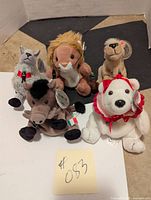 Five Coca-Cola bean stuffed animals arranged on floor, showing all items and tags.