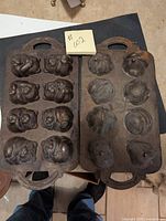 Two open cast iron molds showing multiple animal and bear shaped cavities for chocolate making.