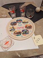 Full set display showing all items in the lot: round tray, two juice glasses, a drink glass and ashtray.