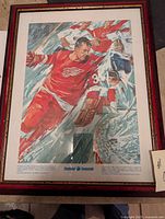 Full view of framed Gordie Howe hockey picture showing the frame and portion of the image.