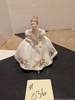 Front view of Royal Doulton figurine Samantha showing full dress, floral decoration, and fan detail
