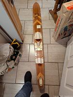 Top view of slalom water ski showing foot bindings and wood design pattern near the tip