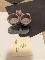 Soapstone bear tea light holder showing front view of the two circular tea light cups and bear figure behind them.