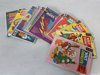 A spread of over 20 vintage Walt Disney's Comics and Stories comic books in varied covers, showing colorful illustrations of Disney characters.