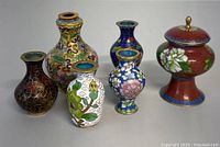 Full set of five Asian cloisonne decorative items photographed together showing size and design variety.
