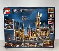 Front view of the LEGO Harry Potter Hogwarts Castle 71043 box showing the assembled castle and detailed insets of interior rooms and figures.