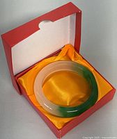 Bangle inside red box with yellow satin fabric lining