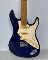 Front view of the blue vintage Aria Pro II electric guitar showing body, pickguard, pickups, and controls