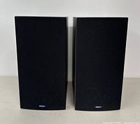Front view of both speakers with black grille covers attached