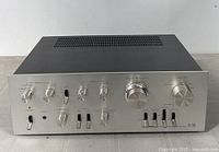 Front perspective view of Pioneer SA-7500 amplifier showing silver faceplate, control knobs, toggle switches and headphone jack
