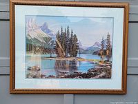Full view of the framed watercolor print featuring a lake scene with pine trees and mountains.