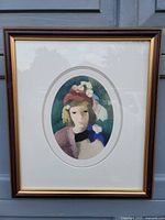 Full view of framed portrait artwork showing the oval top half image of a young woman with hat and flowers, framed in wood and double matted.