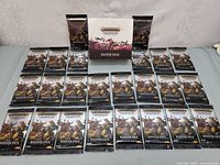 Image showing the opened box with 24 booster packs arranged in four rows of six each, all sealed.