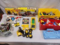 Overview of two boxed sets, storage bins, loose parts and assembled elements