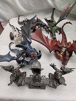 Four detailed dragon figures from Mega Bloks Dragons Krystal Wars with articulated wings and detailed sculpting.