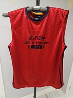 Full front view showing red mesh tank top with navy neckline and side stripe, embroidered with 'HILFIGER DEPT. OF ATHLETICS 8213 5'