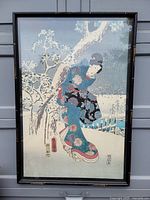 Full view of the framed artwork showing the woman in traditional kimono standing under a snowy tree.