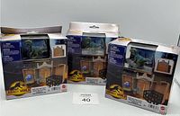Three Jurassic World Dominion Micro Collection Playsets with Blue Raptor figures in original boxes with visible box damage.