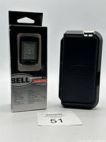 Photo of BELL Dashboard 500 cycling computer in original box alongside black BELL repair kit case.