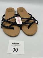 Top view of Bobbie Brooks women's sandals showing braided black straps and tan footbed with size S (5/6) visible on insole