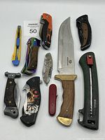 All cutting tools in the lot laid flat on a white surface, clearly showing blades and handles