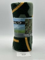 Rolled up view of the travel blanket showing the label with Halo branding and size information.